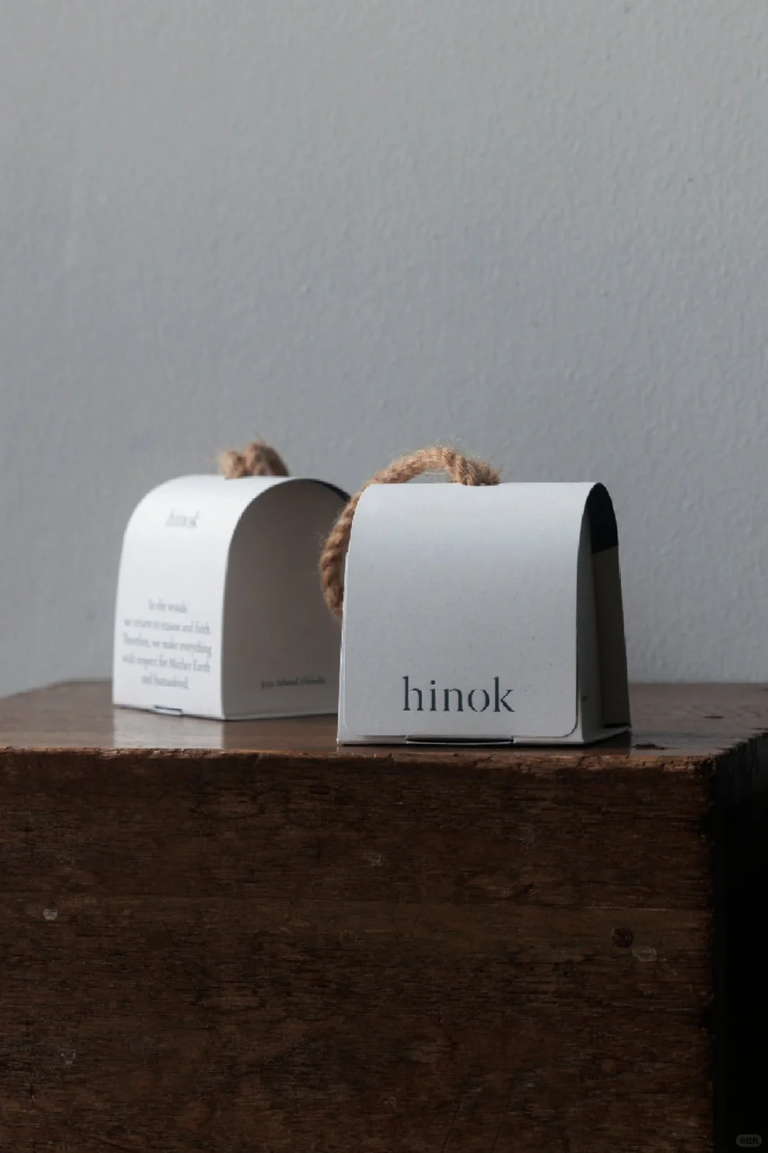 Two compact arched paper packages side by side