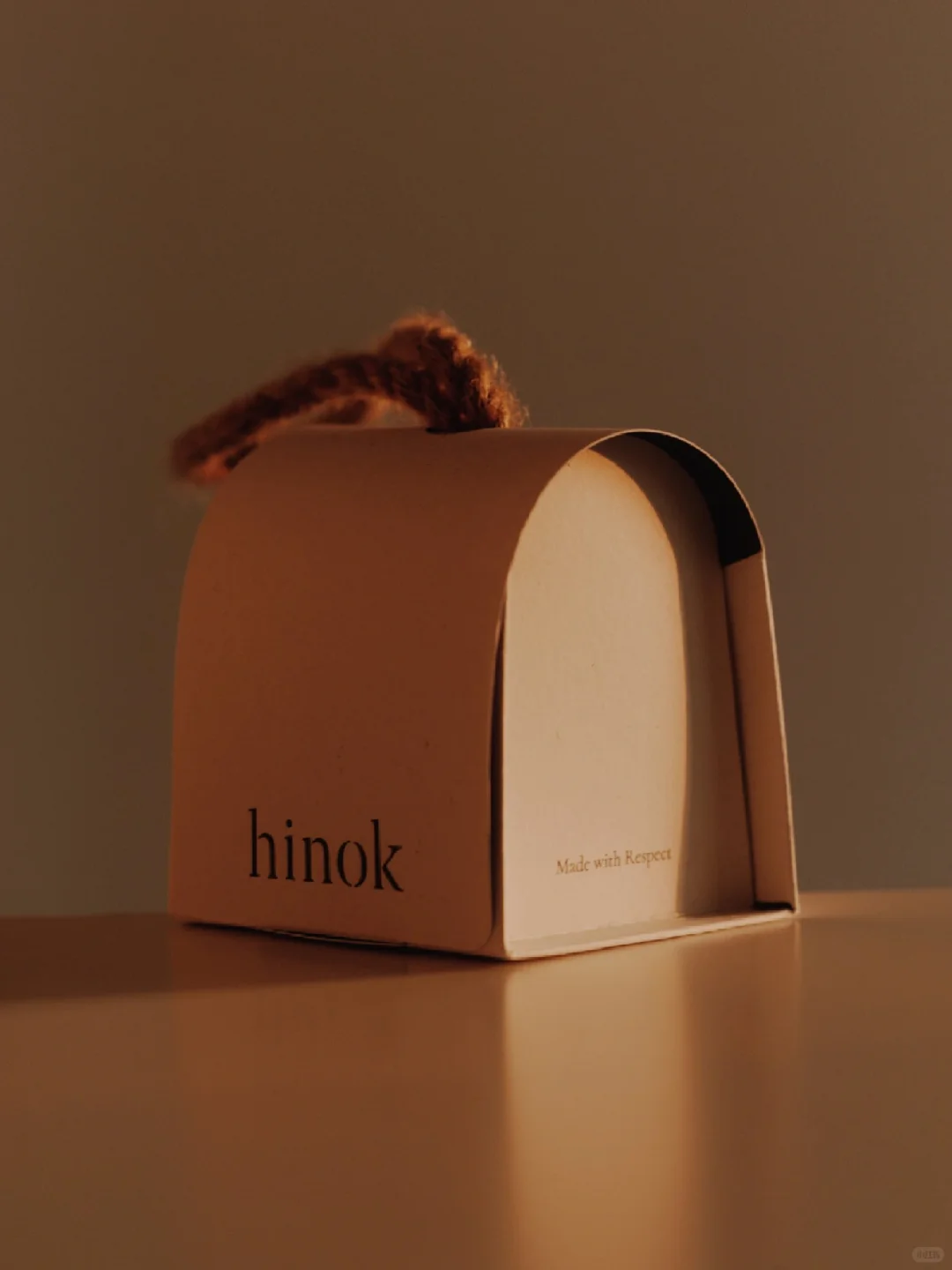 Warm-lit paper package in profile